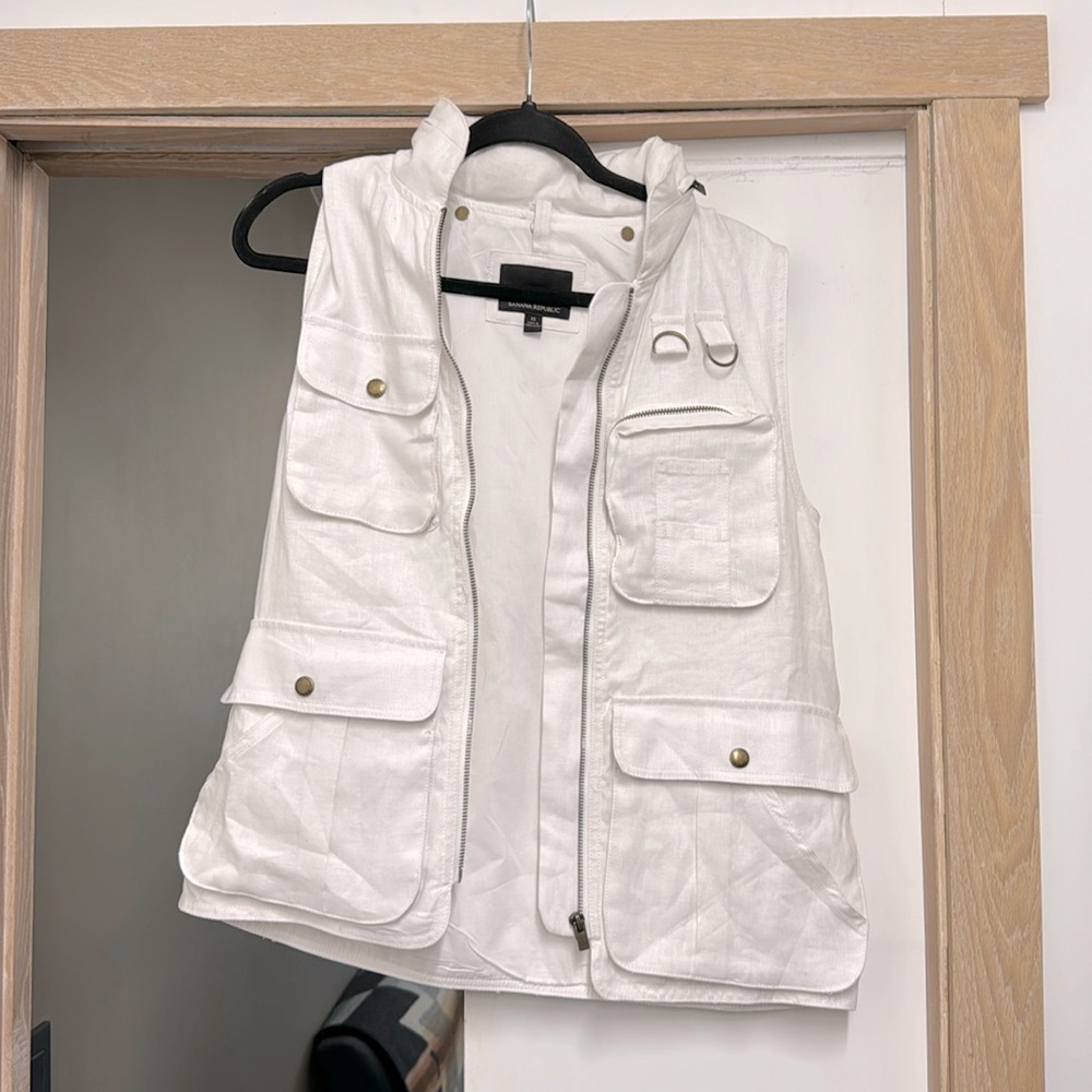 White utility vest. Lots of pockets. Linen and lightweight.